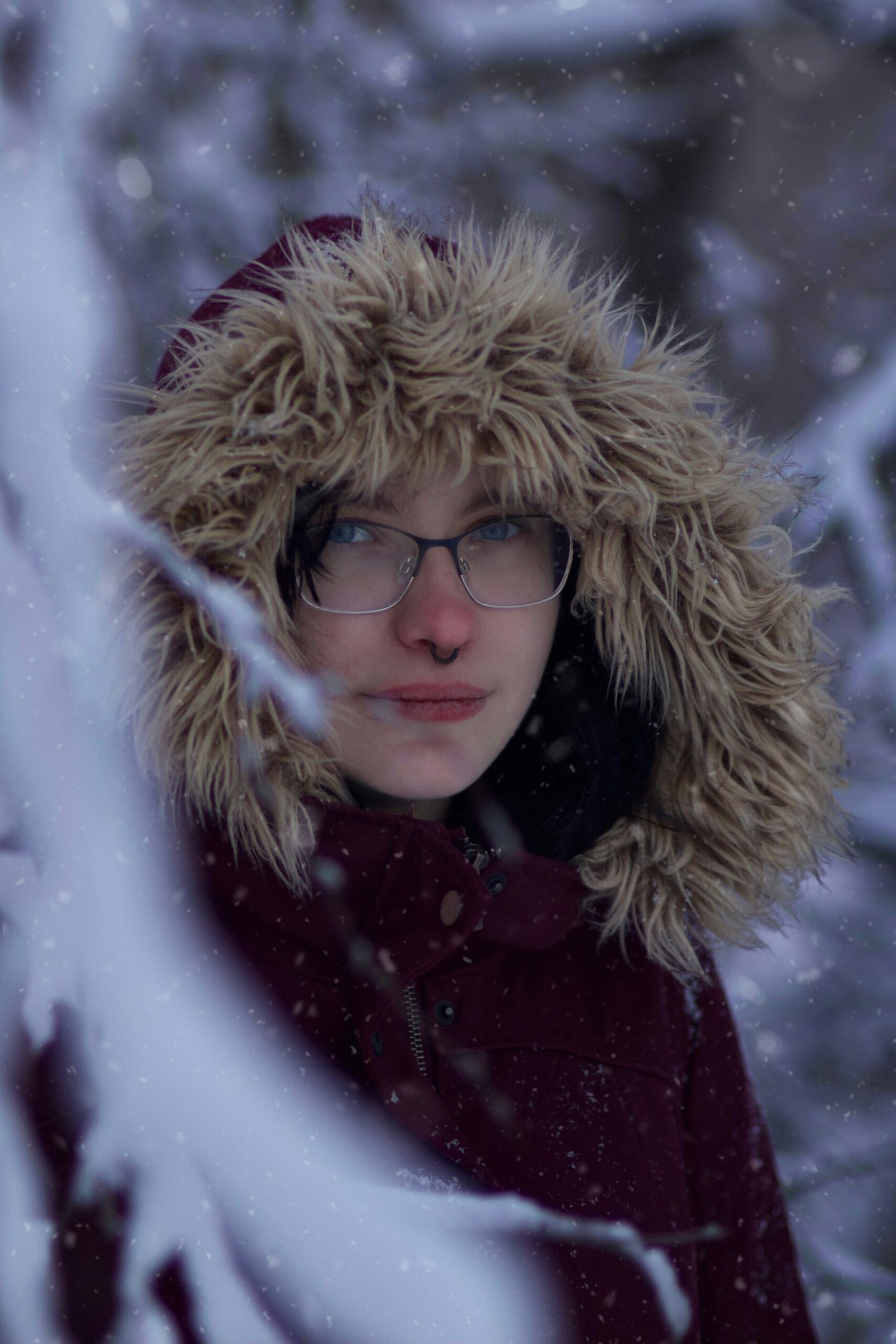 a woman wearing glasses and a fur hat